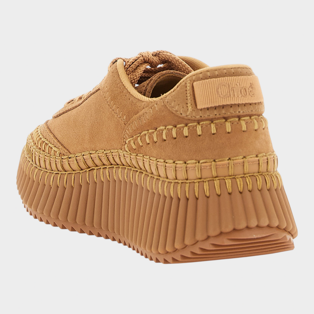 Esmire & Co beige Chloé Nama platform sneakers featuring suede upper, handmade stitching, and grooved rubber sole.