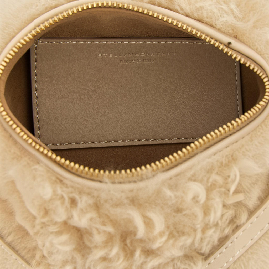 Esmire & Co beige polyester clutch bag interior with Stella McCartney logo embossed on a smooth leather-effect tag.