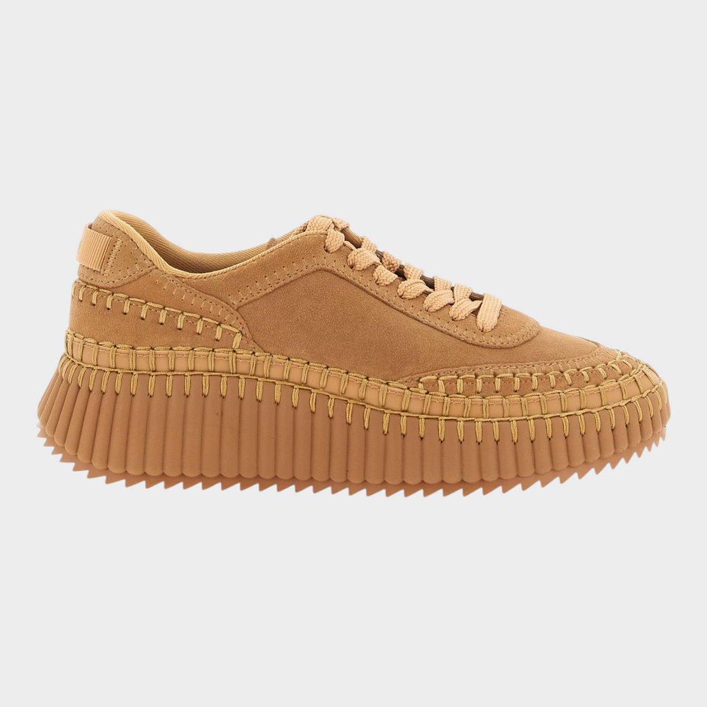 Esmire & Co beige suede platform sneakers with handmade stitching and a grooved rubber sole in a side profile view.
