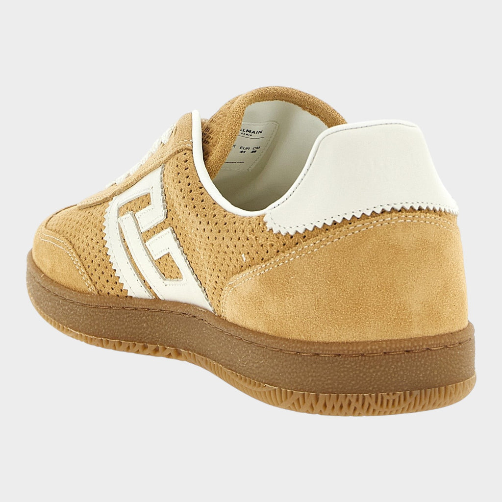 Esmire & Co beige suede low top sneakers with white leather accents, perforated details, and a gum rubber sole.