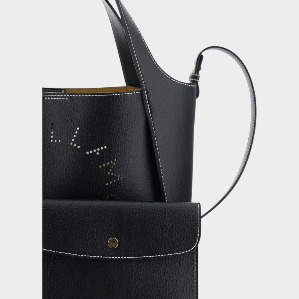 Esmire & Co black grained faux leather handbag with perforated monogram detail and contrast white stitching.