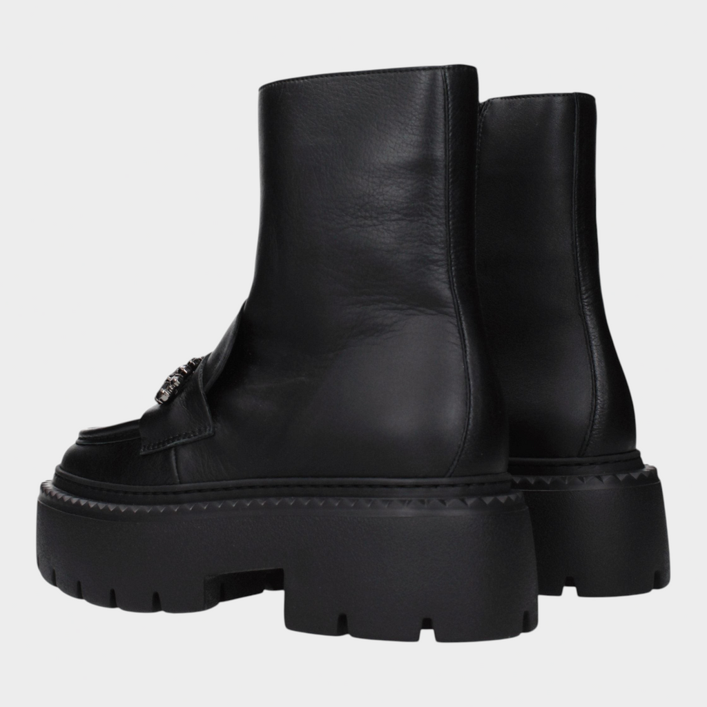 Esmire & Co black leather ankle boots with a chunky platform lug sole and decorative front hardware detail.