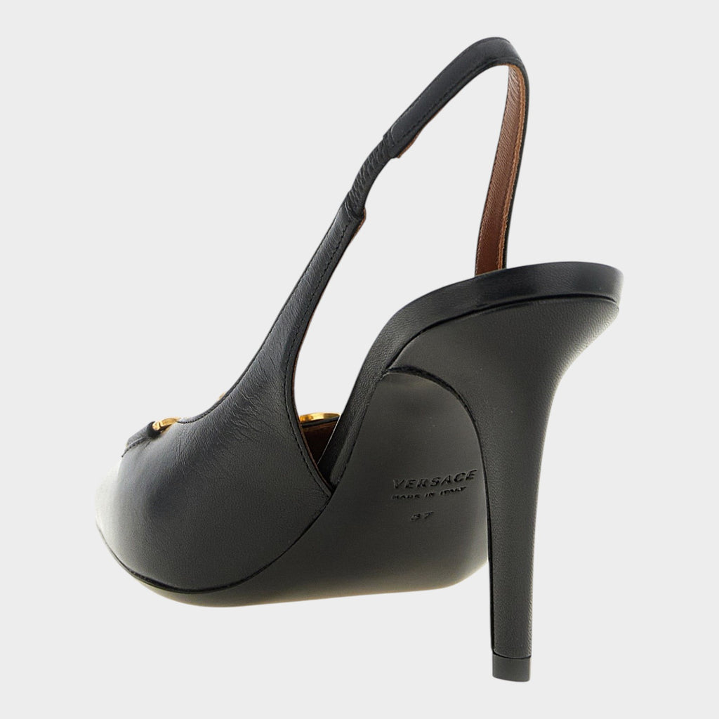 Esmire & Co black lamb leather slingback pumps with stiletto heel and gold Medusa hardware, back view.
