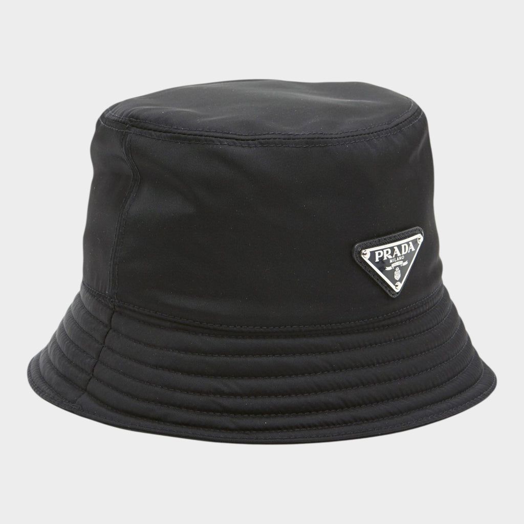 Esmire & Co black nylon bucket hat featuring the iconic Prada triangle logo on the front.