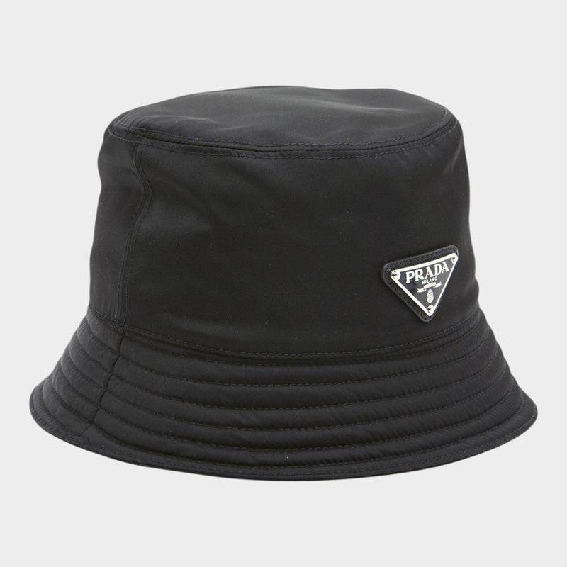 Esmire & Co black nylon bucket hat featuring the iconic Prada triangle logo on the front.
