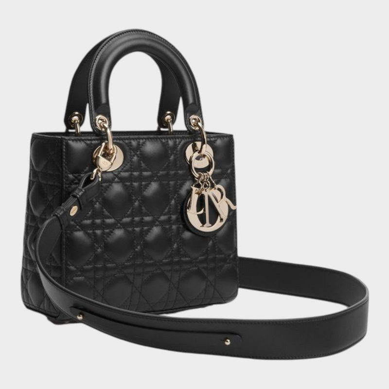 Esmire & Co black quilted lamb leather handbag with pale gold D.I.O.R. charms, top handles, and adjustable strap.