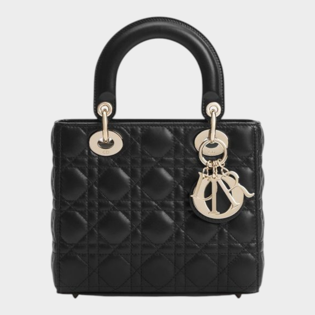 Esmire & Co black quilted lamb leather Dior handbag with pale gold D.I.O.R. charms and top handles.