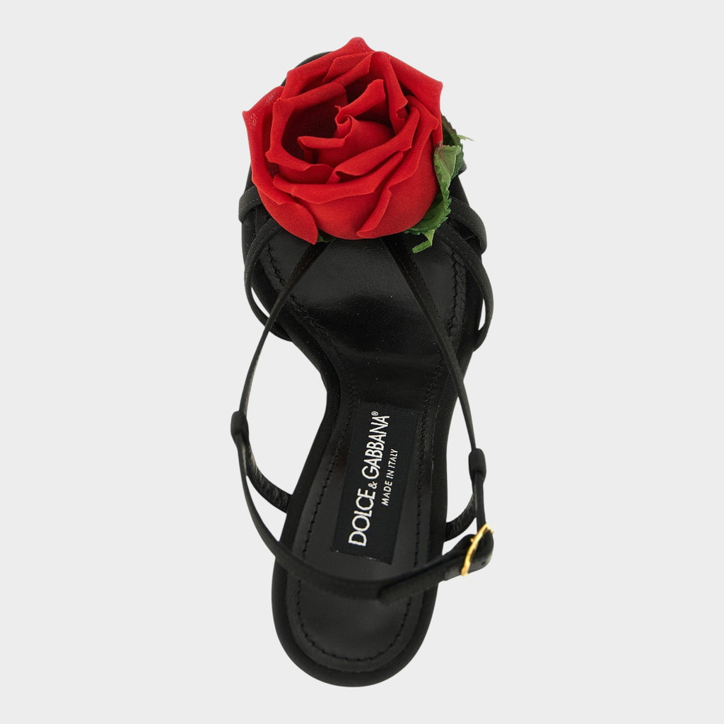 Esmire & Co black viscose stiletto sandals featuring a large red fabric rose and gold DG logo on the leather insole.