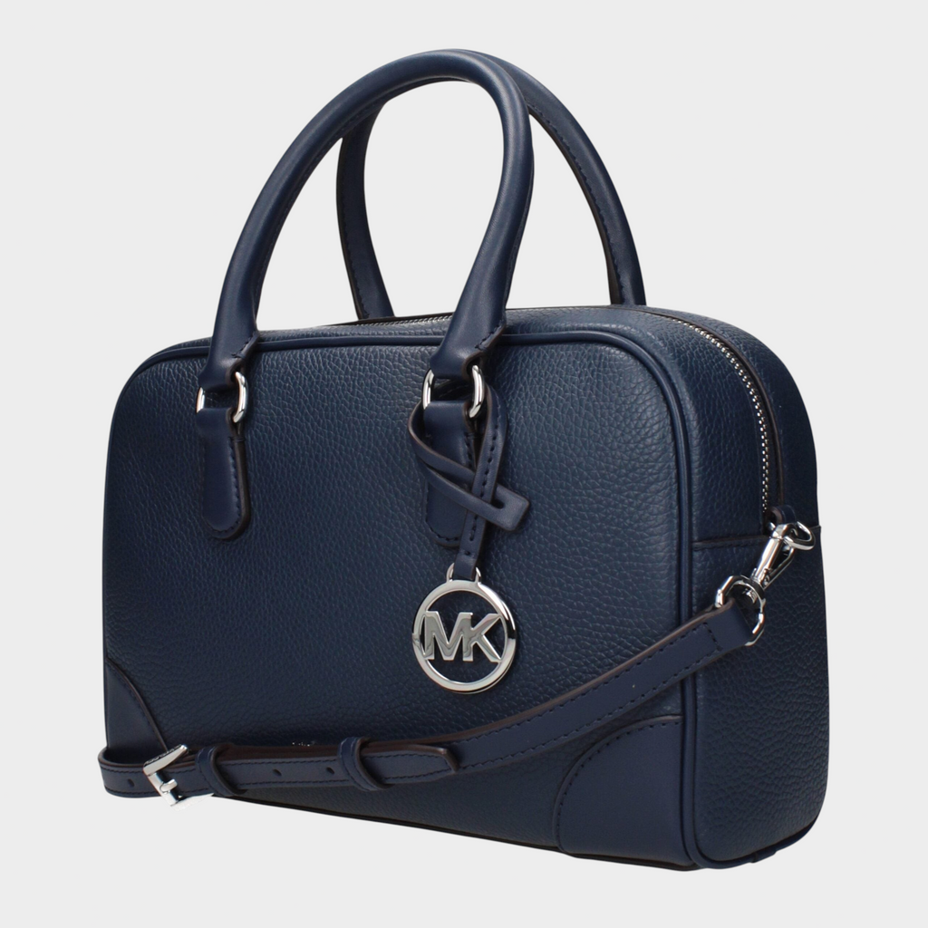Esmire & Co Michael Kors blue leather handbag with silver logo charm, adjustable shoulder strap, and top handles.
