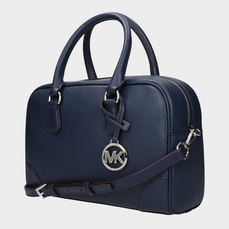 Esmire & Co Michael Kors blue leather handbag with silver logo charm, adjustable shoulder strap, and top handles.