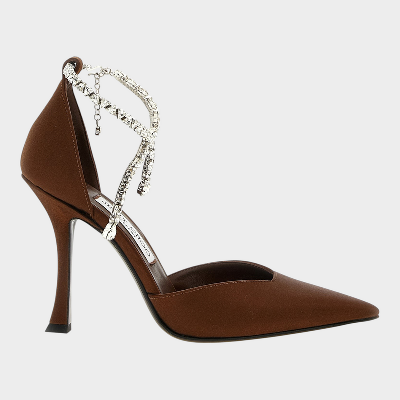 Esmire & Co brown satin Jimmy Choo Stevie pumps with a pointed toe, V-cut instep, and crystal-embellished ankle strap.