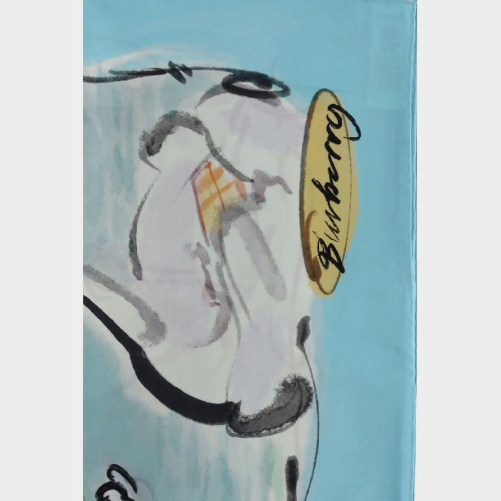 Esmire & Co Burberry Swan Lake silk scarf featuring a light blue background and artistic watercolour swan illustration.
