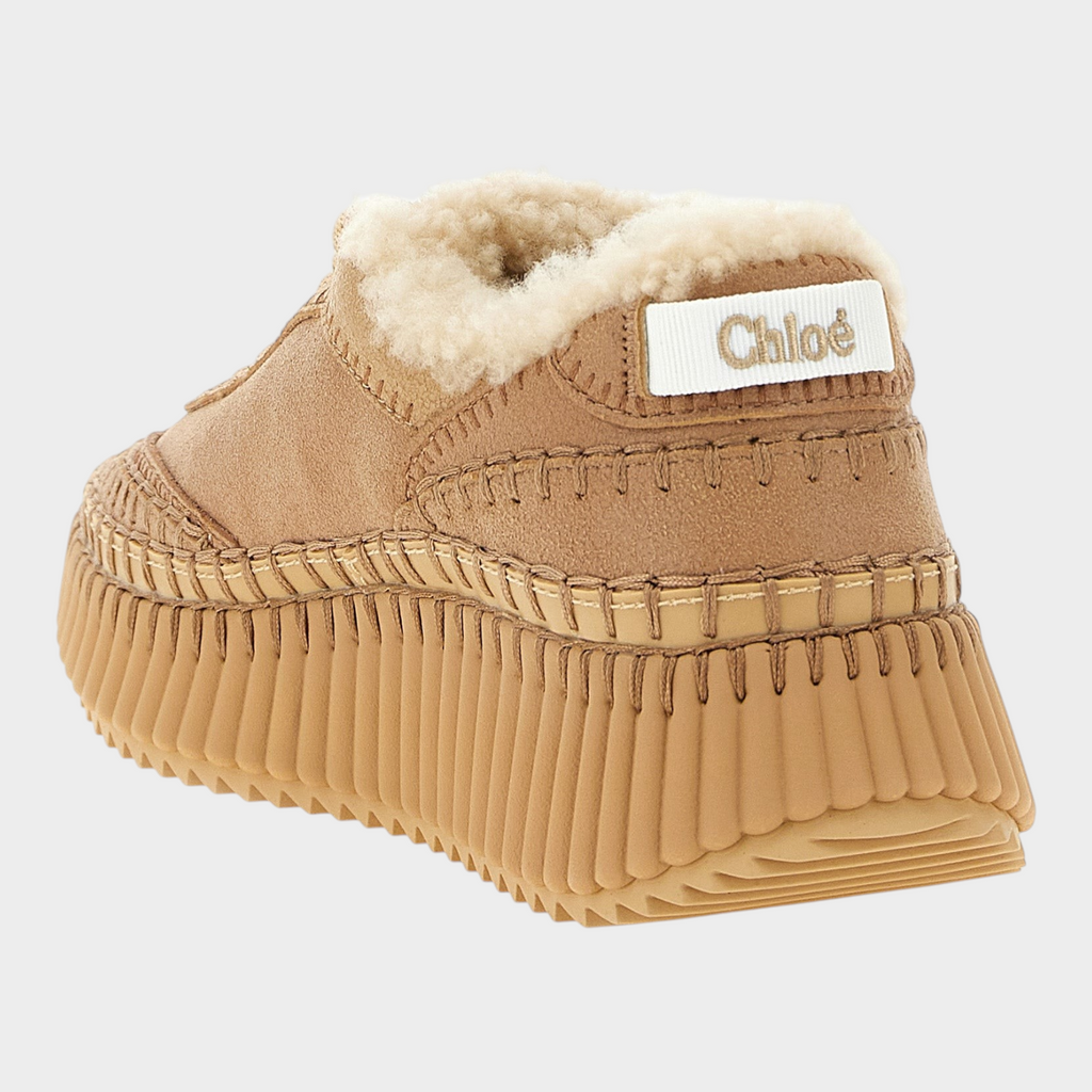 Esmire & Co Chloé Nama beige lambskin chunky sneakers with shearling lining, handmade stitching, and grooved wedge sole.