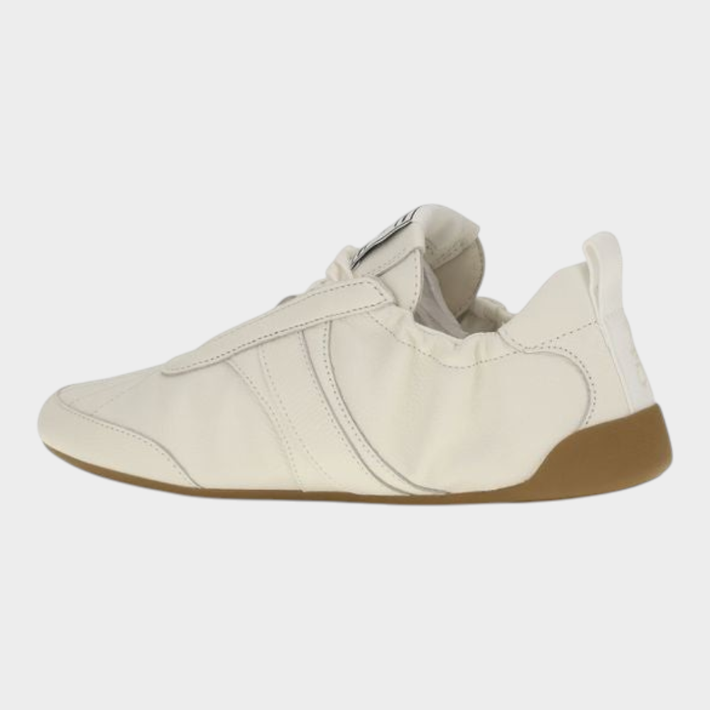Esmire & Co Chloé beige fabric athletic sneakers with a round toe, lace-up design, and flexible rubber sole.