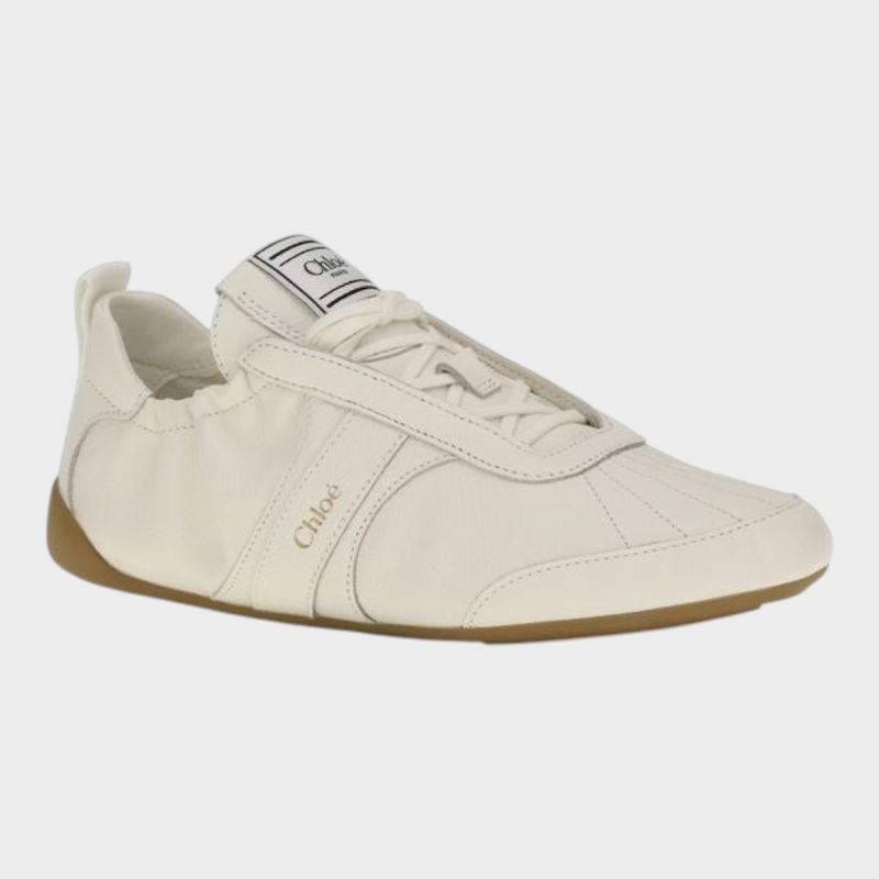 Esmire & Co Chloé beige fabric athletic sneakers with a round toe, lace-up fastening, and flexible rubber sole.