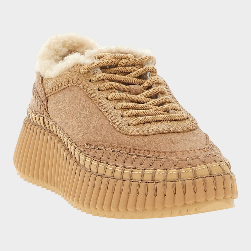 Esmire & Co Chloé Nama beige lambskin chunky sneakers with shearling lining, handmade stitching, and grooved wedge sole.
