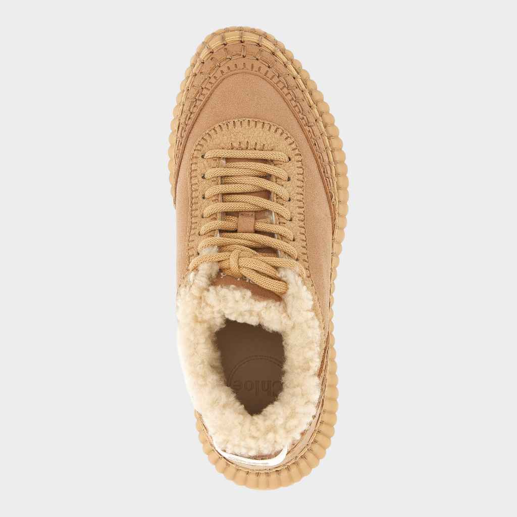 Esmire & Co Chloé Nama beige leather sneakers with shearling lining, handmade stitching, and chunky grooved sole.
