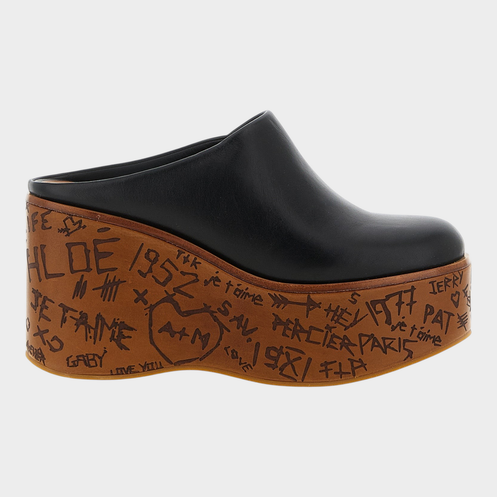 Esmire & Co Chloé black calfskin leather wedge sabot with a sculptural wood-effect platform featuring graffiti art.