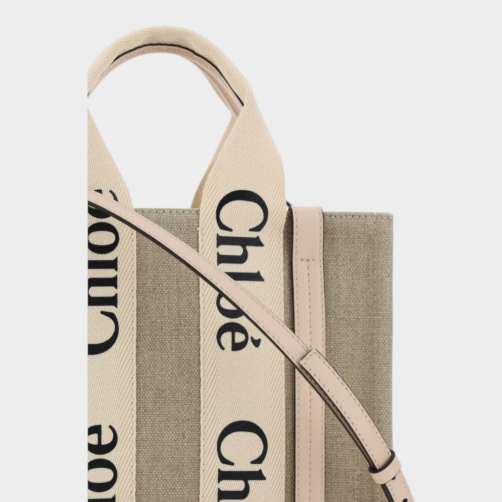 Esmire & Co Chloé Woody brown canvas tote bag with logo-printed straps, leather trim, and adjustable shoulder strap.