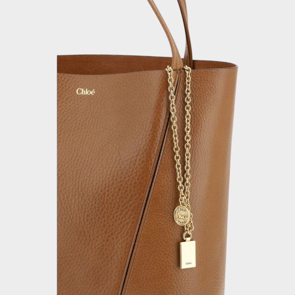 Esmire & Co Chloé brown grained calf leather shoulder bag featuring a gold chain pendant with logo charms