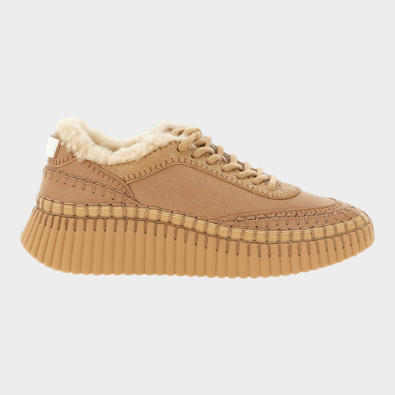 Esmire & Co Chloé Nama beige leather chunky sneakers with shearling lining, handmade stitching, and grooved wedge sole.