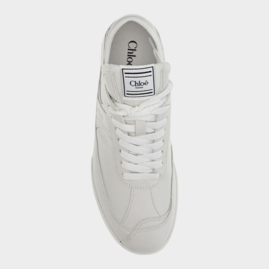 Esmire & Co Chloé white calf leather athletic sneakers with boxing-inspired tongue label, top-down view.