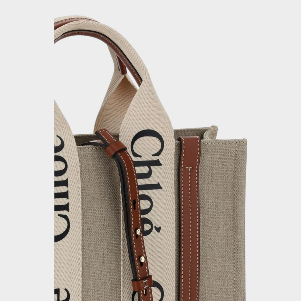 Esmire & Co Chloé Woody canvas tote bag in brown with logo-printed straps, leather trim, and adjustable shoulder strap