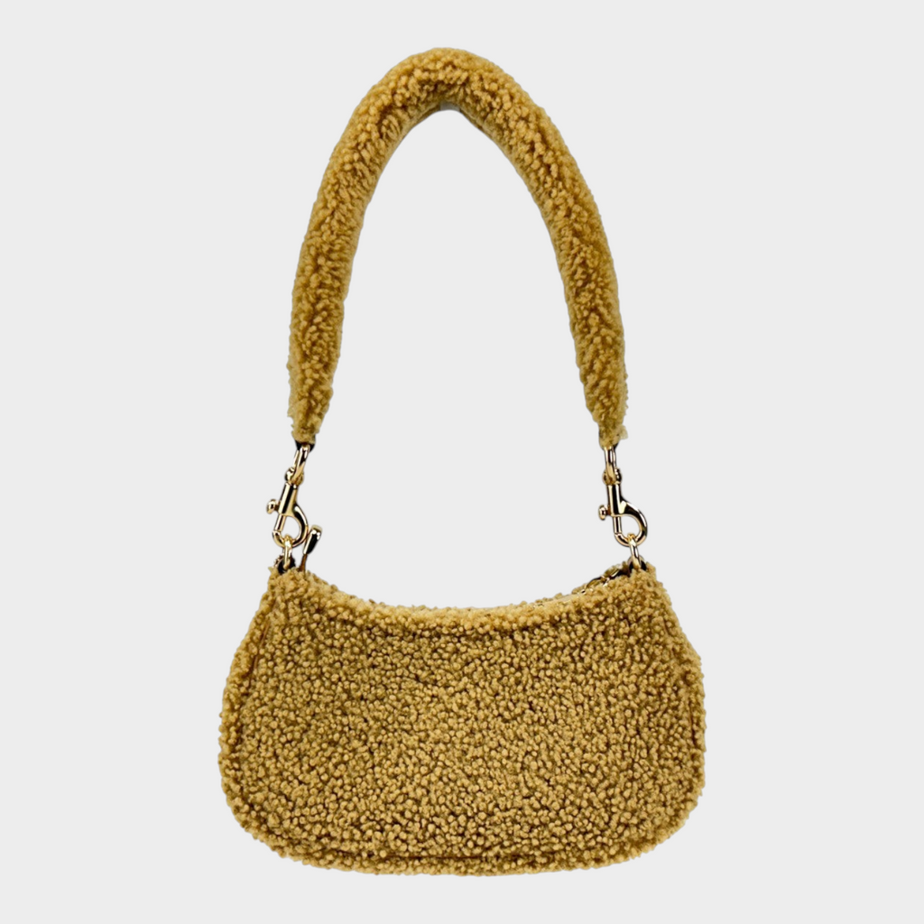Esmire & Co Coach Teri mini shearling fur crossbody bag in natural with gold tone hardware and zip closure.