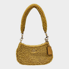 Esmire & Co COACH Teri mini crossbody bag in natural shearling fur with gold tone hardware and zip closure.