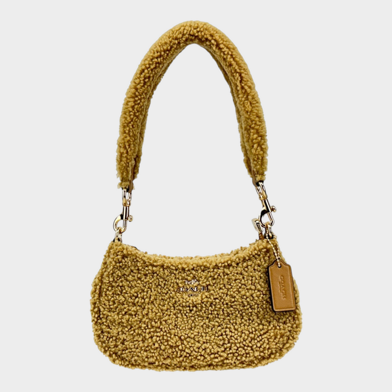 Esmire & Co COACH Teri mini crossbody bag in natural shearling fur with gold tone hardware and zip closure.