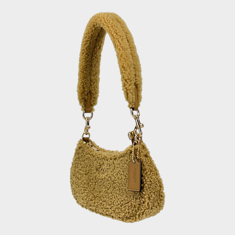 Esmire & Co Coach Teri mini crossbody bag in natural shearling fur with gold tone hardware and zip closure