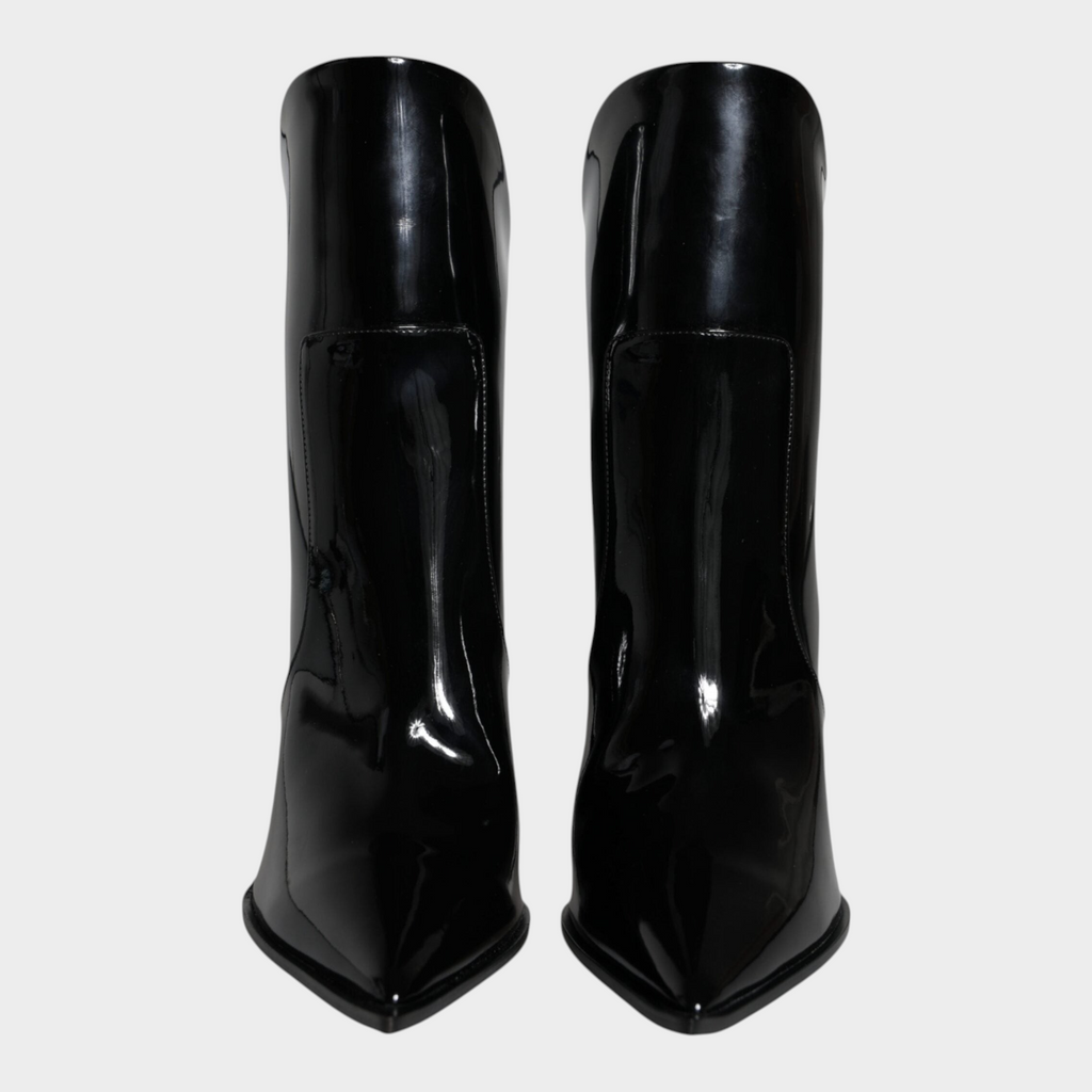 Esmire & Co Dolce & Gabbana black patent leather ankle boots with a sharp pointed toe and sleek high-gloss finish.