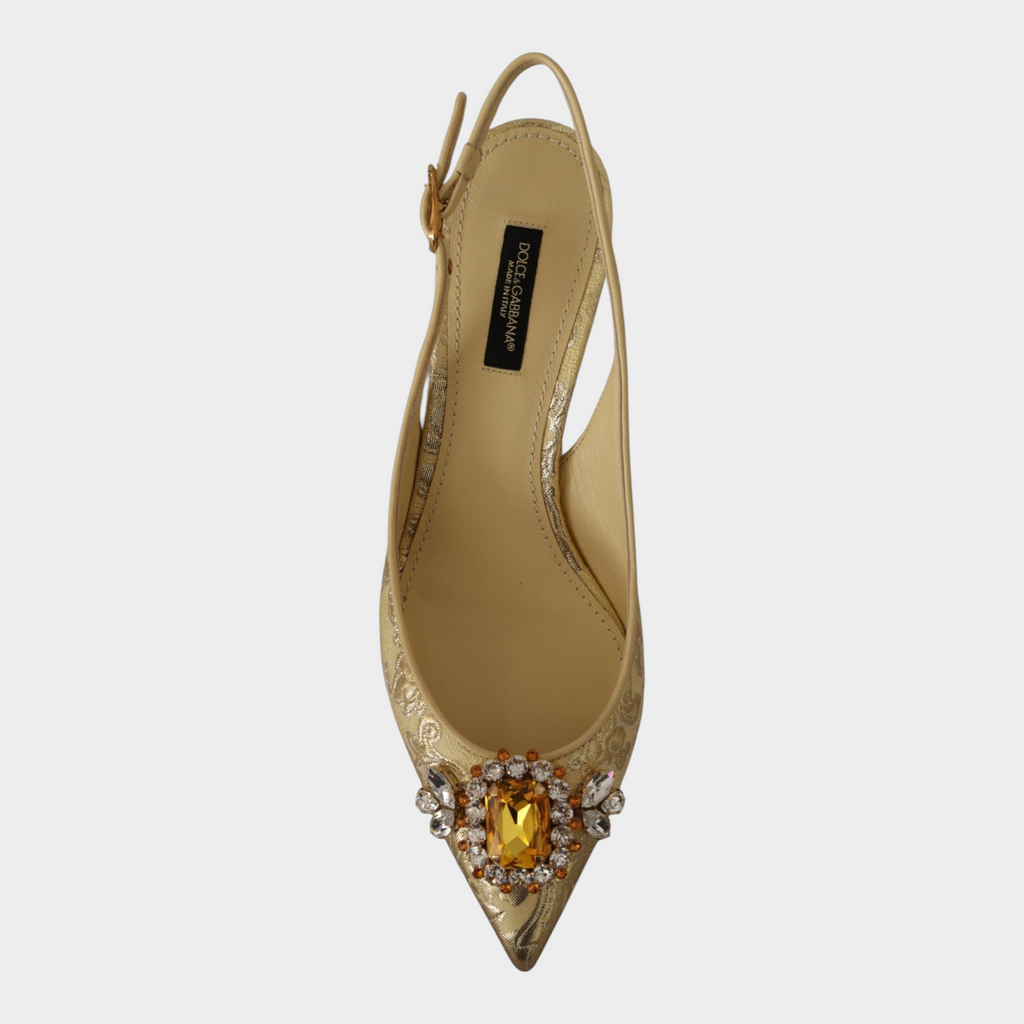Esmire & Co Dolce & Gabbana gold slingback pumps featuring a pointed toe, crystal embellishment, and buckle strap.