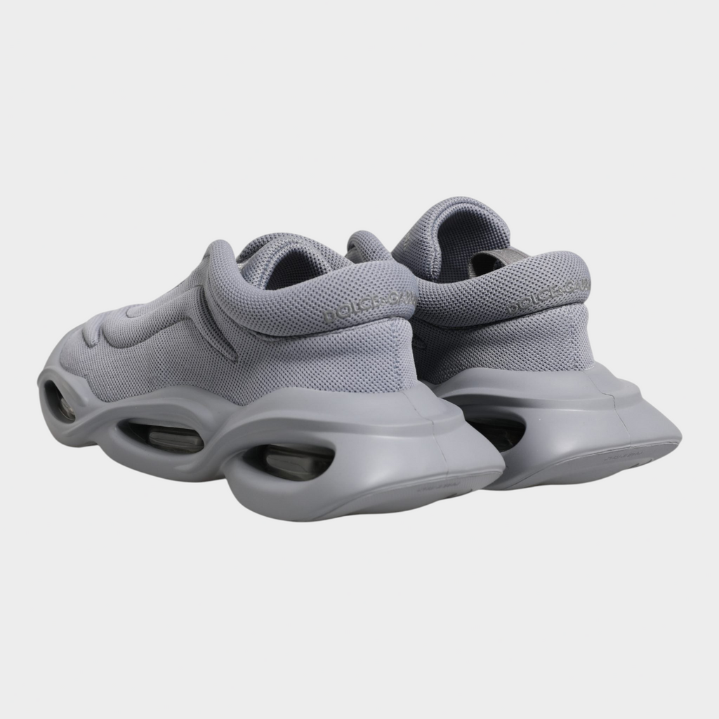 Esmire & Co Dolce & Gabbana grey slip-on sneakers featuring a wave-inspired design and durable rubber sole.