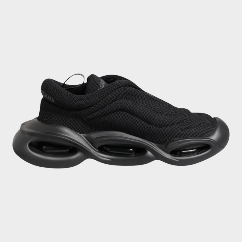 Esmire & Co Dolce & Gabbana Wave low-top sneakers in black featuring a sculptural wave-inspired sole and fabric upper.