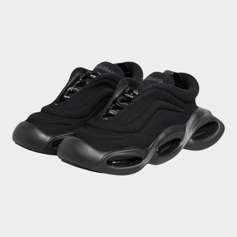 Esmire & Co Dolce & Gabbana Wave low-top sneakers in black with a sculptural wave-inspired sole and lace-up closure.