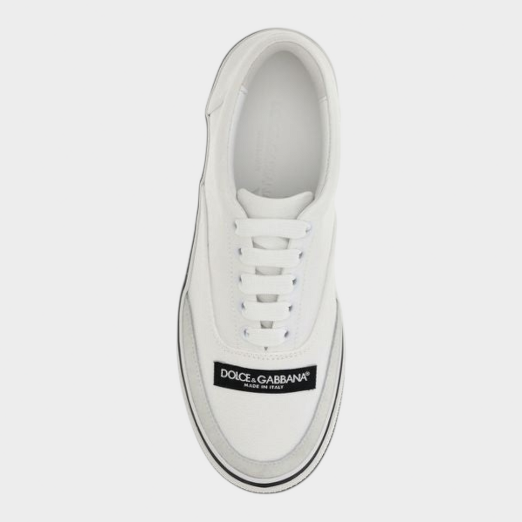 Esmire & Co Dolce & Gabbana white canvas low top sneakers with black logo label and rubber sole, top view.