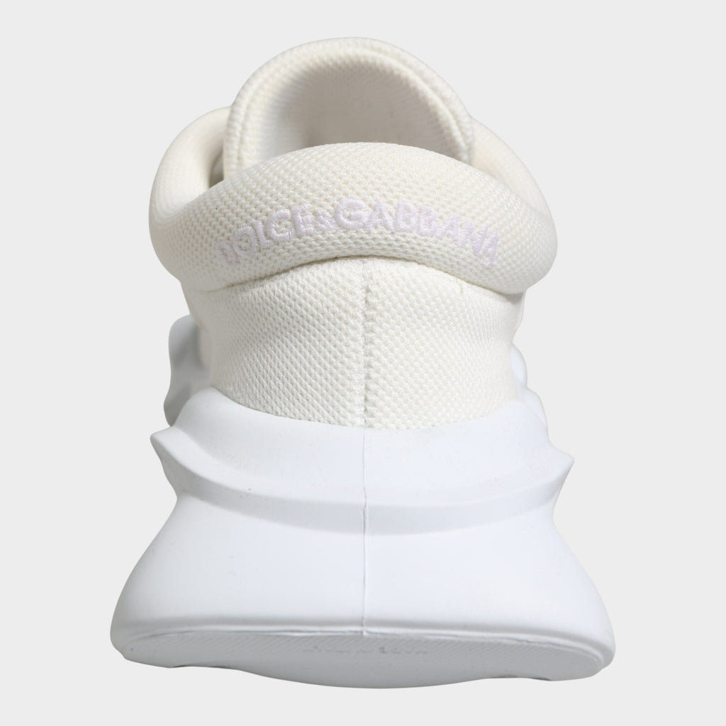 Esmire & Co Dolce & Gabbana white slip-on low top sneakers featuring a textured wave-inspired rubber sole and logo