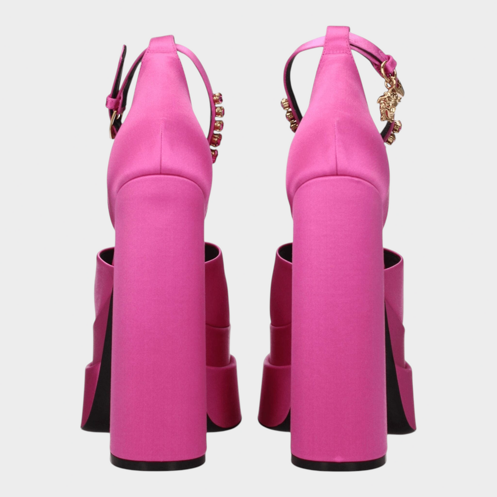 Esmire & Co fuchsia satin platform heels with high block heels, rhinestone accents, and gold logo charm back view.