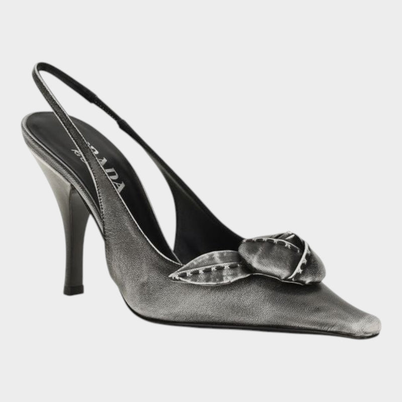 Esmire & Co gray goatskin slingback pumps with a distressed finish, pointed toe, and floral appliqué detail.
