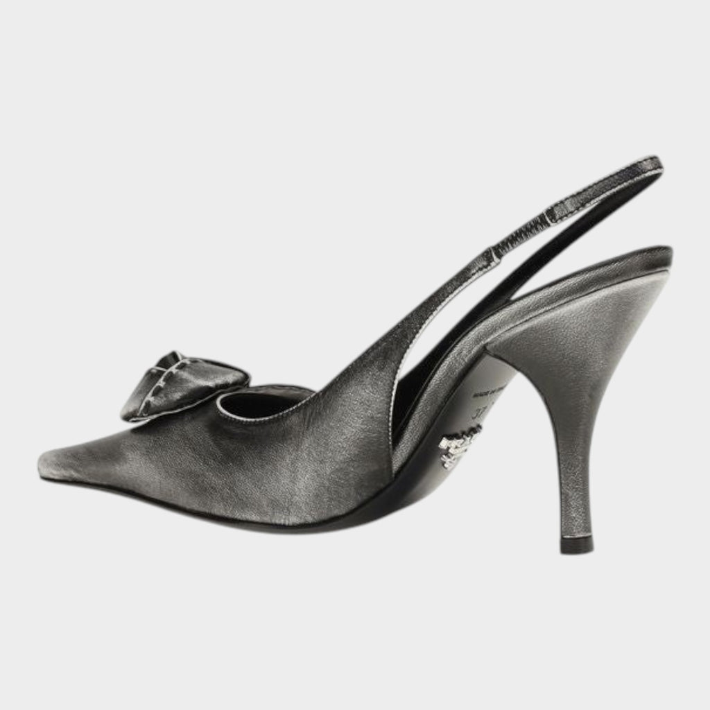 Esmire & Co gray goatskin slingback pumps with a pointed toe, floral appliqué, and 90mm heel in a distressed finish.