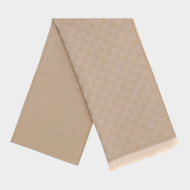 Esmire & Co Gucci beige wool scarf featuring an all-over GG Supreme embroidery and elegant frayed ends.