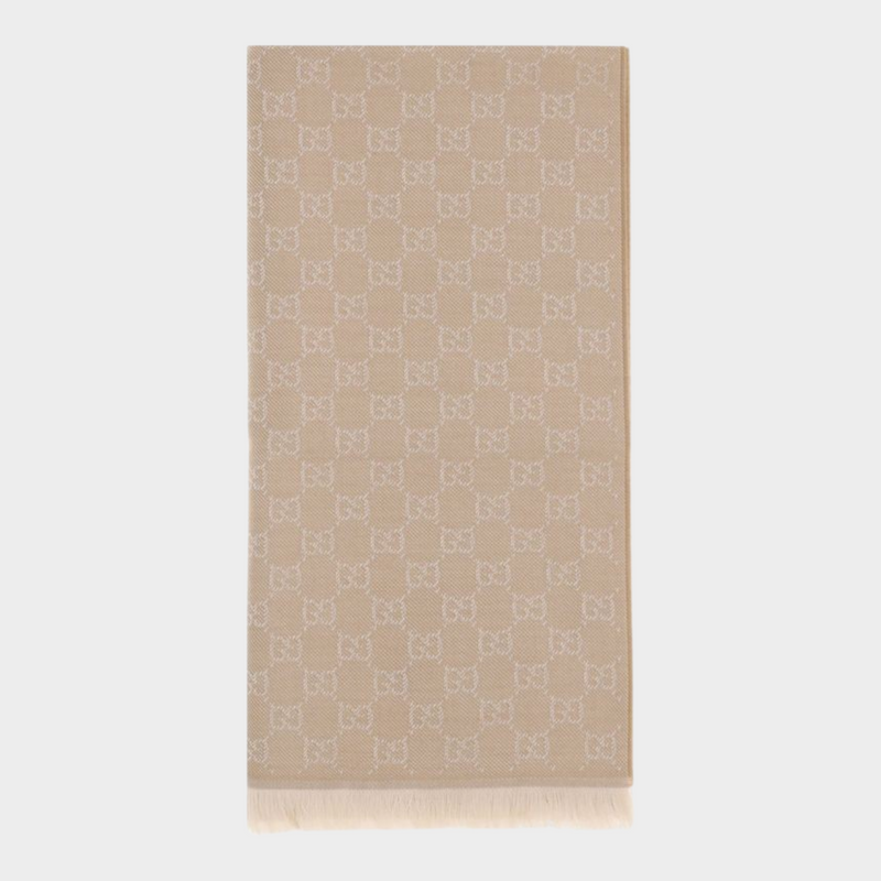 Esmire & Co beige Gucci wool scarf featuring an all-over GG embroidery pattern and elegant frayed ends.