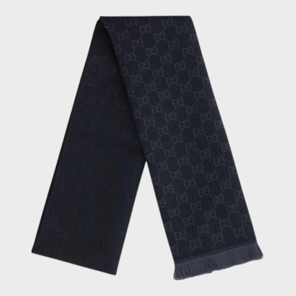 Esmire & Co black wool Gucci scarf featuring an all-over GG logo embroidery and elegant frayed ends.
