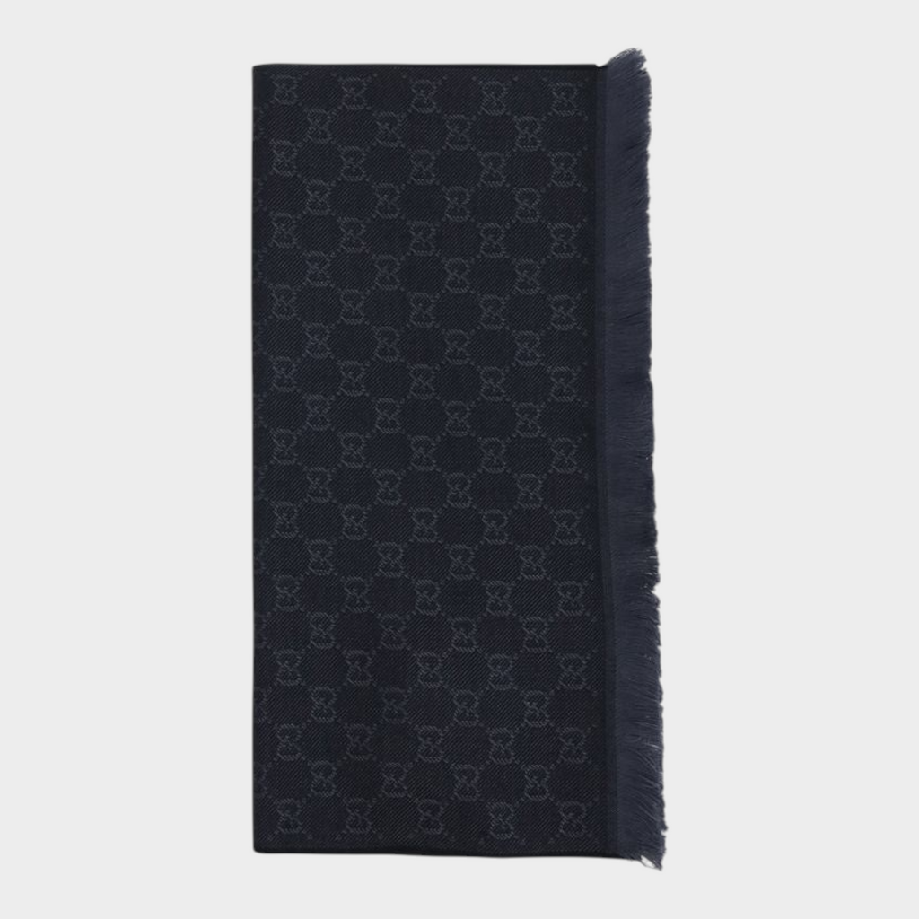 Esmire & Co black wool Gucci scarf featuring an all-over GG logo embroidery and elegant frayed ends.