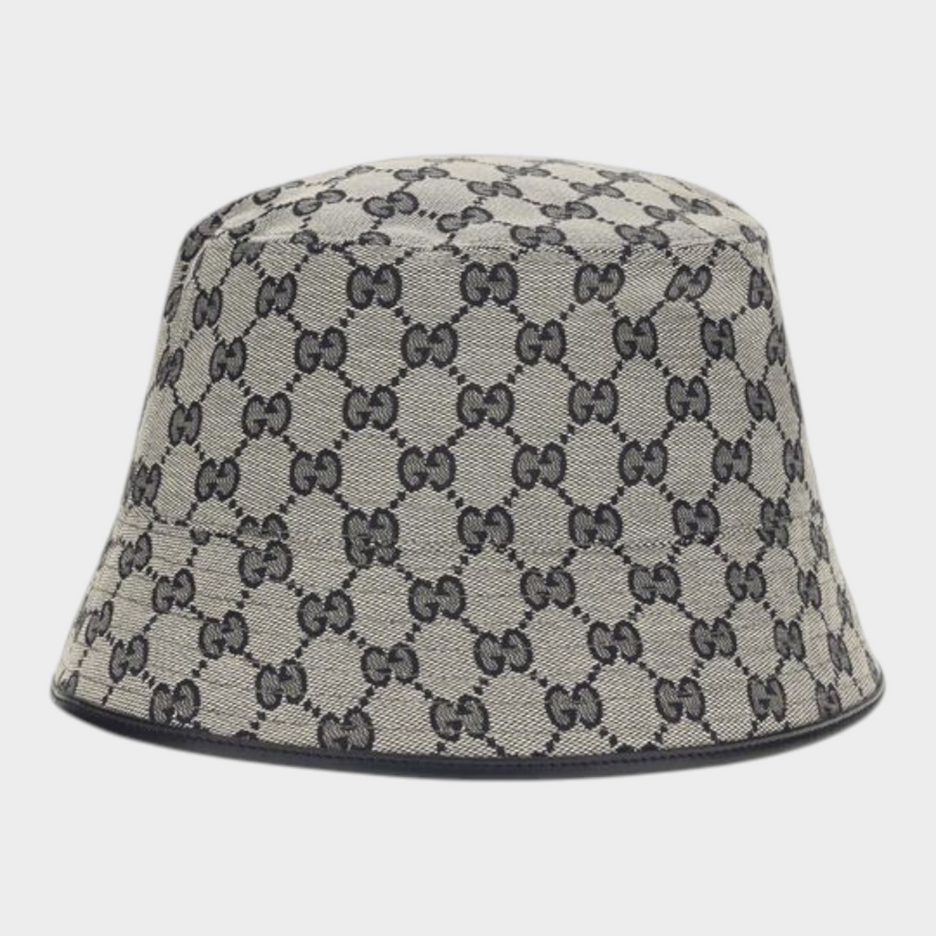 Esmire & Co Gucci gray bucket hat in GG monogram canvas with black leather trim and a classic wide brim silhouette.
