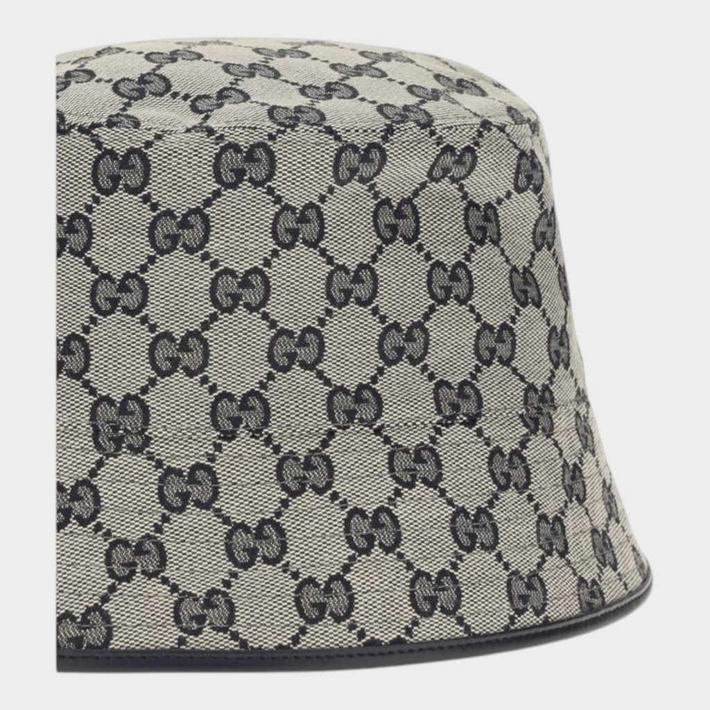 Esmire & Co Gucci gray bucket hat in GG monogram canvas with a refined black leather trim detail.