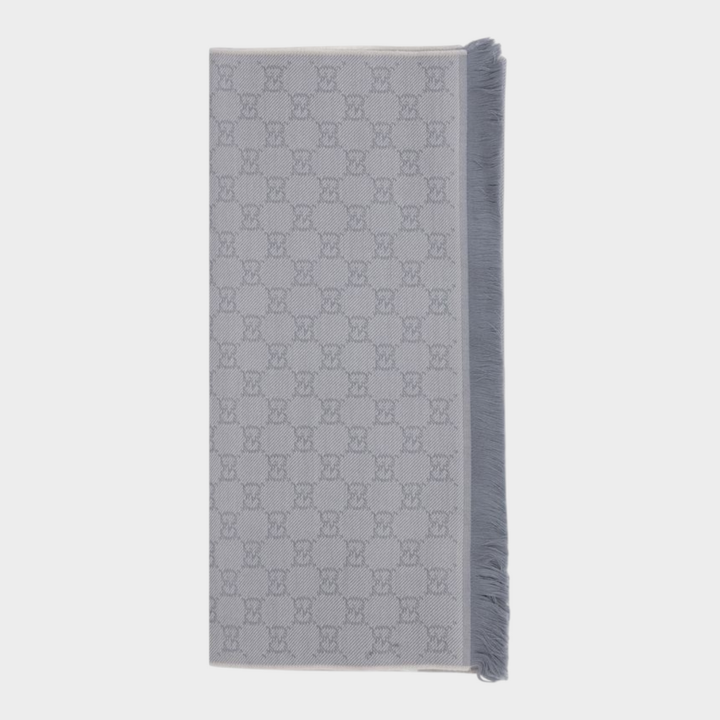 Esmire & Co gray wool Gucci scarf featuring an all-over GG logo embroidery and elegant frayed edge detailing.