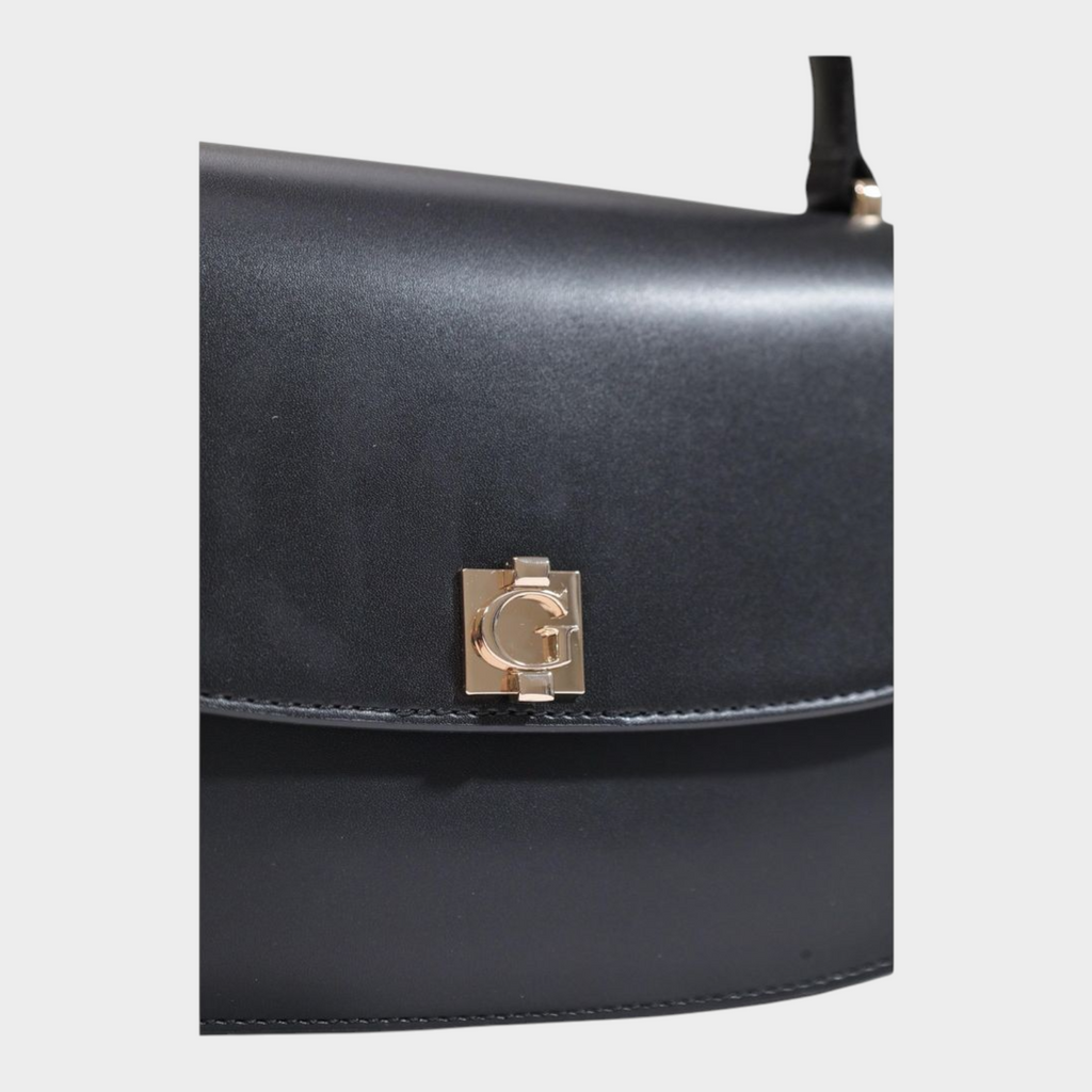 Esmire & Co black Guess handbag featuring a structured polyurethane design with a gold G logo clasp on the front flap