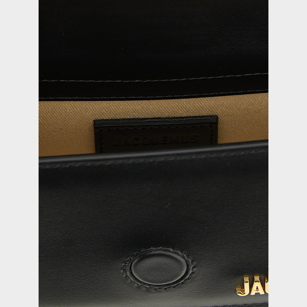 Esmire & Co Jacquemus Le Bambino black cowhide leather handbag interior detail with gold logo branding